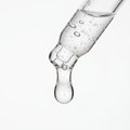 Close-up of niacinamide serum droplet showing lightweight glistening texture